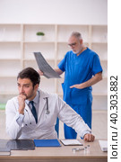 Two male doctors radiologists working in the clinic. Стоковое фото, фотограф Elnur / Фотобанк Лори
