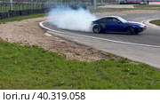 A sports car goes through a turn in a slide. Drift competitions at the Moscow stadium technical sports. Стоковое видео, видеограф Ярославский Максим / Фотобанк Лори