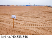 Flat sand subgrade, sign and truck trails. Blue sky on horizon. Стоковое фото, фотограф Alexey Rezvykh / Фотобанк Лори