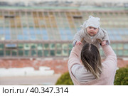 Cute little boy playing with his mom outside. A happy child is tossed up in the park. The kid laughs merrily. Portrait of a boy. Mothers Day. Стоковое фото, фотограф Photojuli / Фотобанк Лори