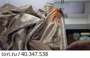 Video of sewing curtains for windows from beige satin fabric on sewing machine. Sewing accessories: pins, curtain tape, thread, meter. Needlework and DIY concept. Стоковое видео, видеограф Виктория Катьянова / Фотобанк Лори