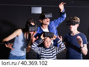 Family with children playfully poses in virtual reality glasses. Стоковое фото, фотограф Яков Филимонов / Фотобанк Лори