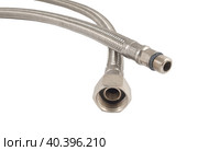 Сантехнический шланг в металлической оплетке для воды на белом фоне. Plumbing hose in a metal braid for water. Стоковое фото, фотограф Татьяна Д / Фотобанк Лори
