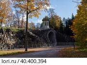 View of the arch "Big Caprice" over the Podkaprizovaya road in the Alexander Park of Tsarskoye Selo on a sunny autumn day, Pushkin, St. Petersburg, Russia. Стоковое фото, фотограф Ula Ulachka / Фотобанк Лори