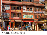 Facades of houses at the Boudhanath stupa in Kathmandu, Nepal (2016 год). Редакционное фото, фотограф Михаил Пряхин / Фотобанк Лори