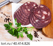 black puddingon served with parley on plate on wooden table. Стоковое фото, фотограф Яков Филимонов / Фотобанк Лори