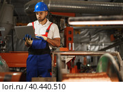 Industrial worker with laptop working in a cable production plant. Стоковое фото, фотограф Сергей Толмачёв / Фотобанк Лори