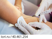 A girl doctor injects a syringe on her arm into a vein of an adult woman. Стоковое фото, фотограф Юрий Поздников / Фотобанк Лори