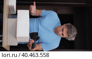 A man is dissatisfied with the purchase of shoes from the store. Bad product. Стоковое видео, видеограф Юрий Поздников / Фотобанк Лори