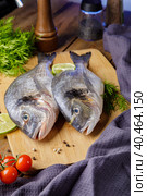 Raw peeled dorado fish with cooking ingredients. Fresh fish on a wooden background. Стоковое фото, фотограф Юрий Поздников / Фотобанк Лори