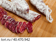 Spanish sausage fuet on a wooden table, closeup. Стоковое фото, фотограф Яков Филимонов / Фотобанк Лори