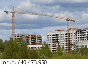 Moscow, Russia - 4 May.2023. Liebherr cranes build residential buildings in Zelenograd. Редакционное фото, фотограф Володина Ольга / Фотобанк Лори