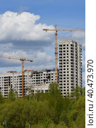 Moscow, Russia - 4 May.2023. Liebherr cranes build residential buildings in Zelenograd. Редакционное фото, фотограф Володина Ольга / Фотобанк Лори