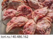 Food background of raw chicken heads. Cat food. Стоковое фото, фотограф Iva Noel / Фотобанк Лори