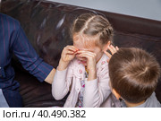 Girl psychologist calms upset girl. The kid is crying. Стоковое фото, фотограф Юрий Поздников / Фотобанк Лори