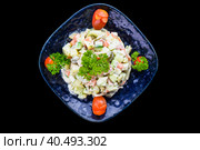 Russian salad olivie on black background top view. Стоковое фото, фотограф Татьяна Терехина / Фотобанк Лори