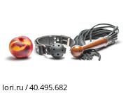 Bdsm leather black gag whip and ripe peach fruit on white background. Стоковое фото, фотограф Артем Курутин / Фотобанк Лори