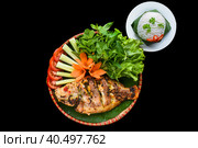 Vietnamese fried fish with rice, greens and vegetables on black background. Стоковое фото, фотограф Татьяна Терехина / Фотобанк Лори