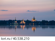 Валдай. Вид на Валдайский Иверский Богородицкий Святоозерский монастырь с отражением в озере (2023 год). Редакционное фото, фотограф Литвяк Игорь / Фотобанк Лори