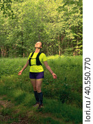 Woman jogger doing warm-up exercises in natural forest park. Стоковое фото, фотограф Евгений Харитонов / Фотобанк Лори