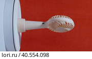 Portable fan on a stand. Rotates on the subject table. On a coral background. Стоковое видео, видеограф Vadzim Yakubovich / Фотобанк Лори