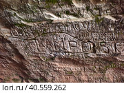 Latvia, Sigulda, 29,04,2016Natural cave in sandstone rock, former bank of Gauja river. Carved wall in Gutmanis cave in Sigulda, Latvia. Редакционное фото, фотограф Анна Кривицкая / Фотобанк Лори