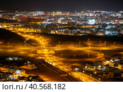 Aerial view of the night city of Muscat - the capital of the Sultanate of Oman. Road junctions and houses illuminated at night (2023 год). Стоковое фото, фотограф Евгений Ткачёв / Фотобанк Лори