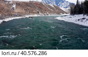 Горный Алтай зимой: хребет Айгулак, река Катунь. Вид с воздуха. Altai mountains in winter: Aigulak ridge, Katun River. Aerial view. Стоковое видео, видеограф Евгений Романов / Фотобанк Лори