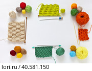 Square composition with knitting accessories: balls of colorful wool yarn, knitting needles and samples of different types of knitting on a white background. Frame for text, top view, copy space, flat lay. Стоковое фото, фотограф Виктория Катьянова / Фотобанк Лори