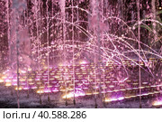 Light and music fountain on a summer evening. Natural Museum-reserve "Tsaritsyno". Colorful fountain in Tsaritsyno Park at night. (2023 год). Редакционное фото, фотограф Photojuli / Фотобанк Лори