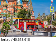 Russia, Moscow, June 2023 The City Sihgtseeng double-decker sightseeing bus runs through the center of Moscow. Red bus on the background of St. Basil's Cathedral. Редакционное фото, фотограф Photojuli / Фотобанк Лори