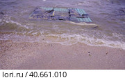Part of wall of house floats near shore, floating debris has reached Black Sea beaches in Odessa, Ukraine. Environmental disaster caused by explosion of Kakhovka Hydroelectric Power Plant dam, closeup. Стоковое фото, фотограф Некрасов Андрей / Фотобанк Лори