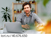 Smiling man photographer or retoucher working from home. Стоковое фото, фотограф Сергей Толмачёв / Фотобанк Лори