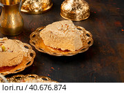 Piece of turkish halva on metal plate. Стоковое фото, фотограф Сергей Толмачёв / Фотобанк Лори