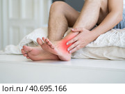 Joint inflammation, foot pain, man suffering from feet ache at home, podiatry concept. Стоковое фото, фотограф Станислав Тарко / Фотобанк Лори