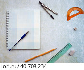 Open notebook with blank page. There is a blue pen on the notebook. The compass, ruler, pencil and protractor are next to the notebook. Empty space. Стоковое фото, фотограф Бузмакова Светлана / Фотобанк Лори