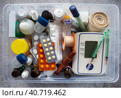 First aid kit with medicines, tonometer, thermometers, dressings, syringes, inhalers and medical supplies. Medical background with medicines and products for the prevention and treatment of diseases. Стоковое фото, фотограф Бузмакова Светлана / Фотобанк Лори