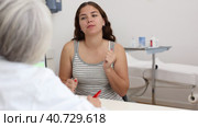 Young woman consulting with faceless beautician on anti-aging treatments in cosmetology clinic. Стоковое видео, видеограф Яков Филимонов / Фотобанк Лори