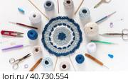 Video with handmade lacy tricolor doilies, set of cotton yarn, crochet hooks, scissors and pins on white background. DIY concept and handmade gifts. Flat lay, top view, close-up. Стоковое видео, видеограф Виктория Катьянова / Фотобанк Лори