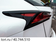 Closeup of rear red taillight on white suv. Back lights of modern car. Стоковое фото, фотограф Константин Григорьев / Фотобанк Лори