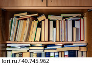 The bookcase is filled with books. Monographs, textbooks, scientific and fiction literature are placed on the shelves. Background for libraries, science, education. Стоковое фото, фотограф Бузмакова Светлана / Фотобанк Лори