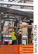 A man-welder fastens iron girders with a welding machine. Construction of the station. Стоковое фото, фотограф Юрий Поздников / Фотобанк Лори