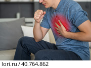 Sore throat and cough, man with lung pain at home. Стоковое фото, фотограф Станислав Тарко / Фотобанк Лори