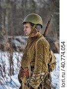 LENINGRAD REGION, RUSSIA - JANUARY 22, 2012: The german gunners during the Second world war to occupy the position. Military-historical reconstruction of the battle that broke the siege of Leningrad. Редакционное фото, фотограф Анна Кривицкая / Фотобанк Лори