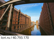 Famous landmark old Speicherstadt in Hamburg, build with red bricks. Bridge in low angle view (2018 год). Стоковое фото, фотограф Igor Tichonow / Фотобанк Лори