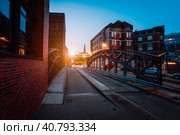 Empty Poggenmuehlen Bridge at twilight. Hamburg, Germany. illuminated buildings and last sunrays. Warehouse District -Speicherstadt Landmark of HafenCity quarter. Most visited touristic famous place (2018 год). Стоковое фото, фотограф Igor Tichonow / Фотобанк Лори