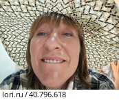 Funny, amusing girl or woman with chubby cheeks wearing a straw hat. The concept of trickery and amusement. Стоковое фото, фотограф Кривошеина Елена Леонидовна / Фотобанк Лори