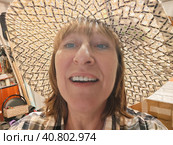 Funny, amusing girl or woman with chubby cheeks wearing a straw hat. The concept of trickery and amusement. Стоковое фото, фотограф Кривошеина Елена Леонидовна / Фотобанк Лори