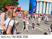 Girl fan English team with painted on the cheek flag is in the fanzone at the festival of fans in Volgograd (2018 год). Редакционное фото, фотограф Сергей Сергеев / Фотобанк Лори