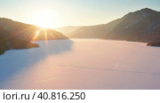 Горный Алтай зимой: Рассвет на Телецком озере. Вид с воздуха. Altai mountains in winter: Dawn on the Teletskoye Lake. Aerial view. Стоковое видео, видеограф Евгений Романов / Фотобанк Лори